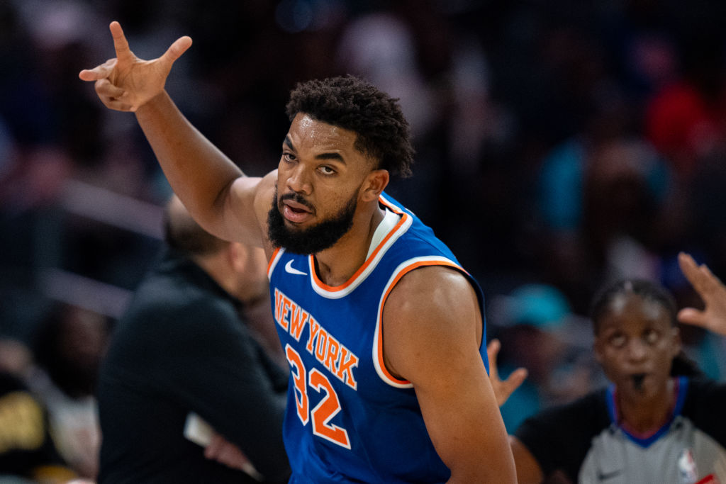 CHARLOTTE, NORTH CAROLINA - OCTOBER 06: Karl-Anthony Towns #32 of the New York Knicks reacts in the first quarter during a preseason game against the Charlotte Hornets at Spectrum Center on October 06, 2024 in Charlotte, North Carolina