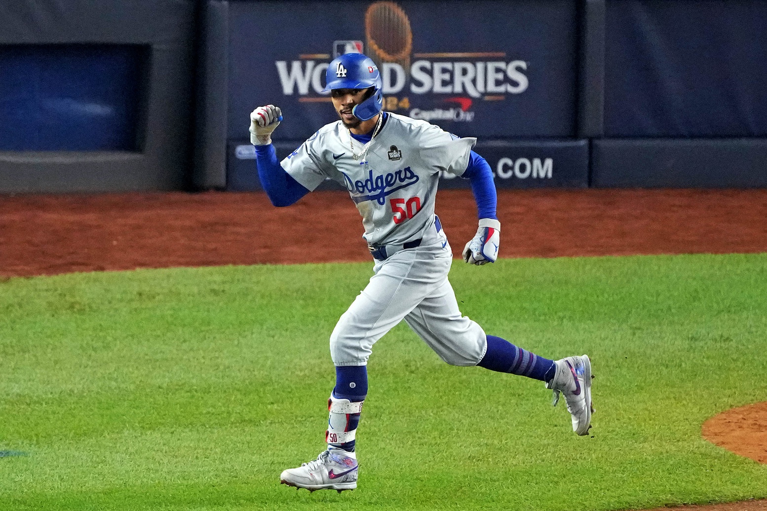 Oct 30, 2024; New York, New York, USA; Los Angeles Dodgers shortstop Mookie Betts (50) celebrates after hitting a sacrifice fly during the eighth inning against the New York Yankees in game four of the 2024 MLB World Series at Yankee Stadium.