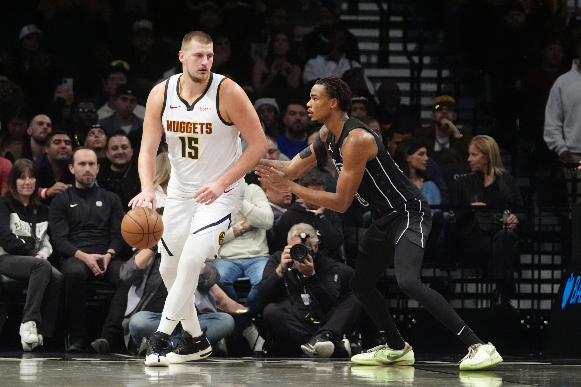 Oct 29, 2024; Brooklyn, New York, USA; Denver Nuggets center Nikola Jokic (15) dribbles the ball against Brooklyn Nets center Nic Claxton (33) during the second half at Barclays Center.