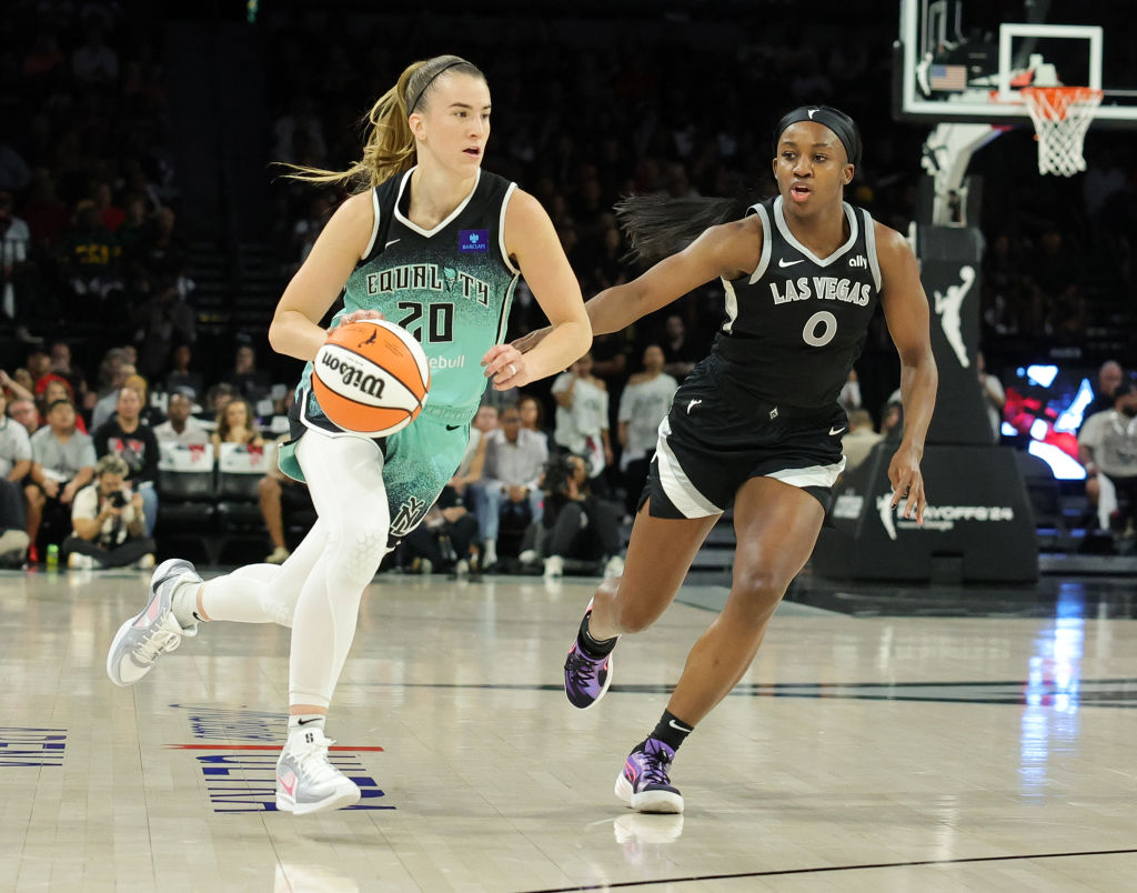 LAS VEGAS, NEVADA - OCTOBER 06: Sabrina Ionescu #20 of the New York Liberty drives against Jackie Young #0 of the Las Vegas Aces in the third quarter of Game Four of the 2024 WNBA Playoffs semifinals at Michelob ULTRA Arena on October 06, 2024 in Las Vegas, Nevada. The Liberty defeated the Aces 76-62 to win the series three games to one. NOTE TO USER: User expressly acknowledges and agrees that, by downloading and or using this photograph, User is consenting to the terms and conditions of the Getty Images License Agreement.