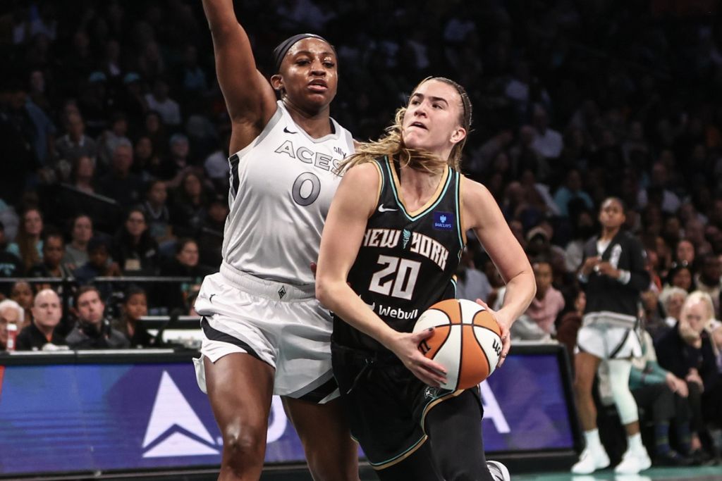 Oct 1, 2024; Brooklyn, New York, USA; New York Liberty guard Sabrina Ionescu (20) looks to drive past Las Vegas Aces guard Jackie Young (0) in the third quarter during game two of the 2024 WNBA Semi-finals at Barclays Center. Mandatory Credit: Wendell Cruz-Imagn Images