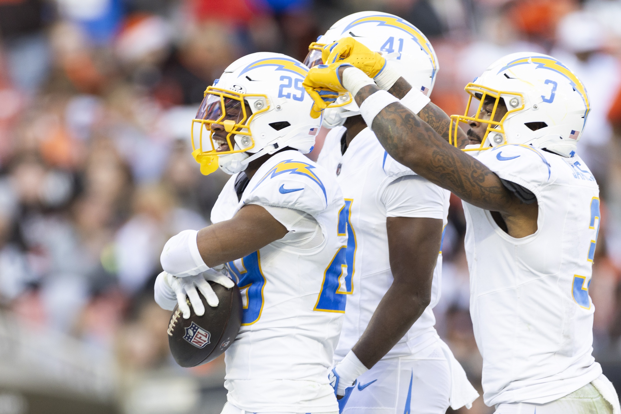 Nov 3, 2024; Cleveland, Ohio, USA; Los Angeles Chargers cornerback Tarheeb Still (29) celebrates his interception with safety Derwin James Jr. (3) and cornerback Eli Apple (41) during the fourth quarter against the Cleveland Browns at Huntington Bank Field.