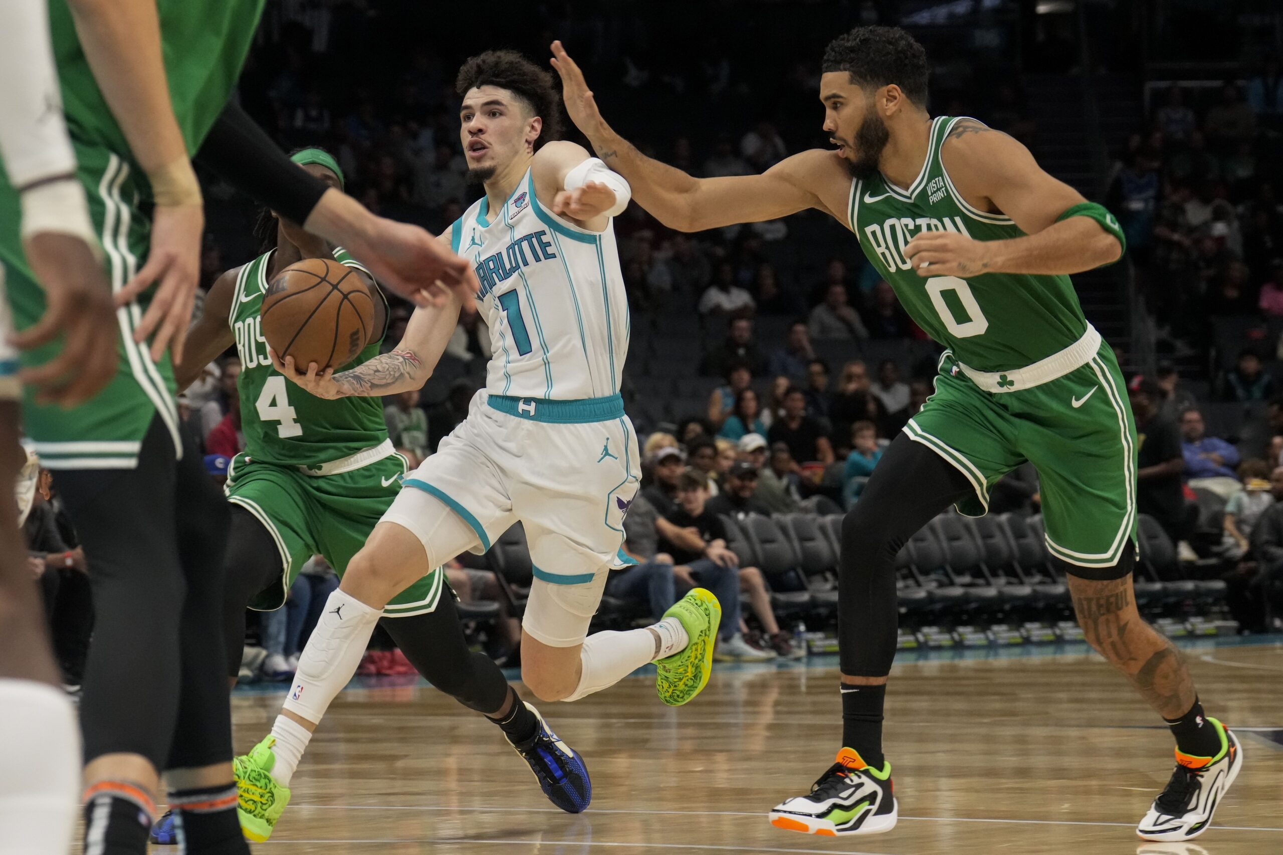 Oct 19, 2023; Charlotte, North Carolina, USA; Charlotte Hornets guard LaMelo Ball (1) drives to the basket covered by Boston Celtics forward Jayson Tatum (0) during the second half at Spectrum Center.