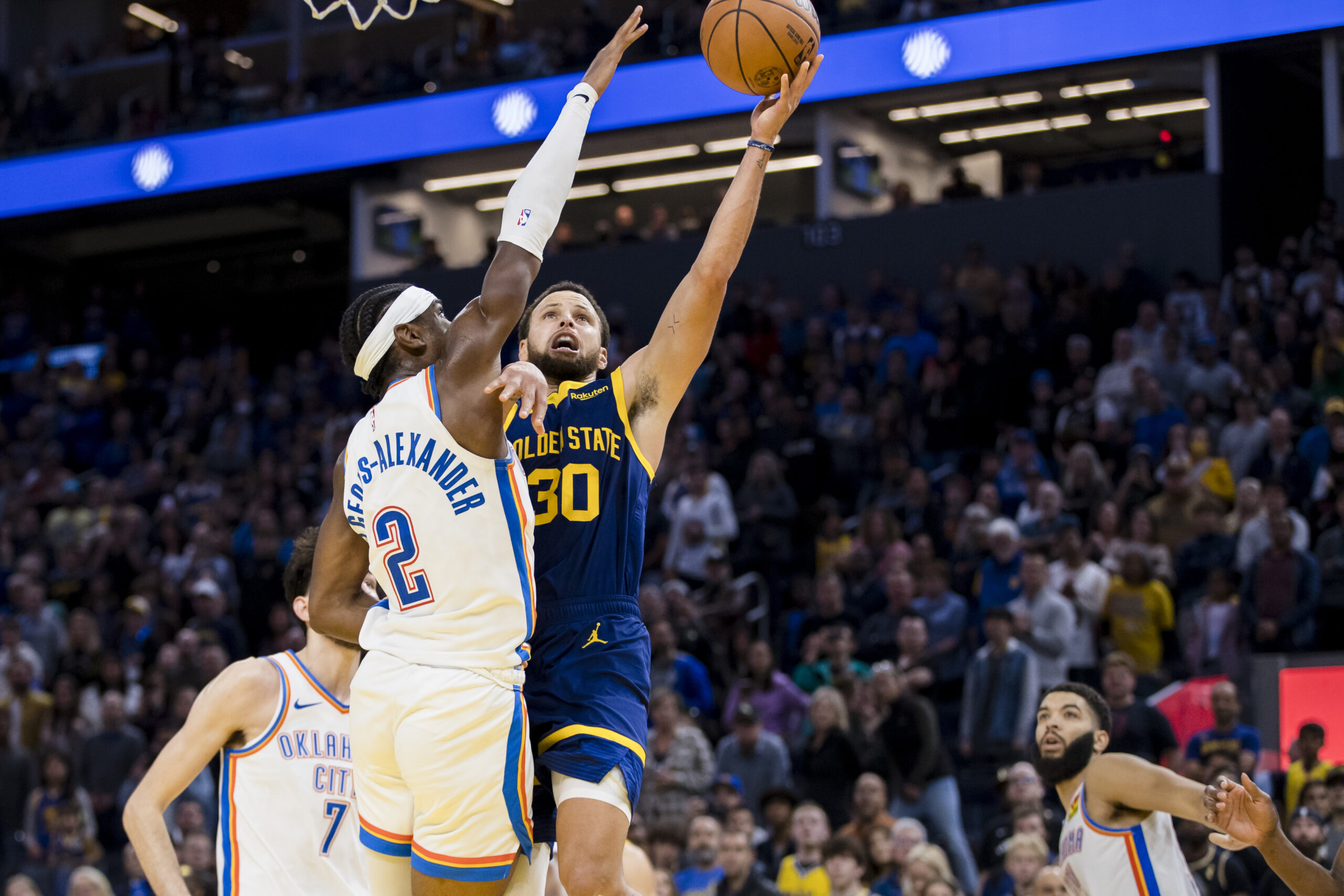 Nov 18, 2023; San Francisco, California, USA; Oklahoma City Thunder guard Shai Gilgeous-Alexander (2) defends Golden State Warriors guard Stephen Curry (30) during the second half at Chase Center.