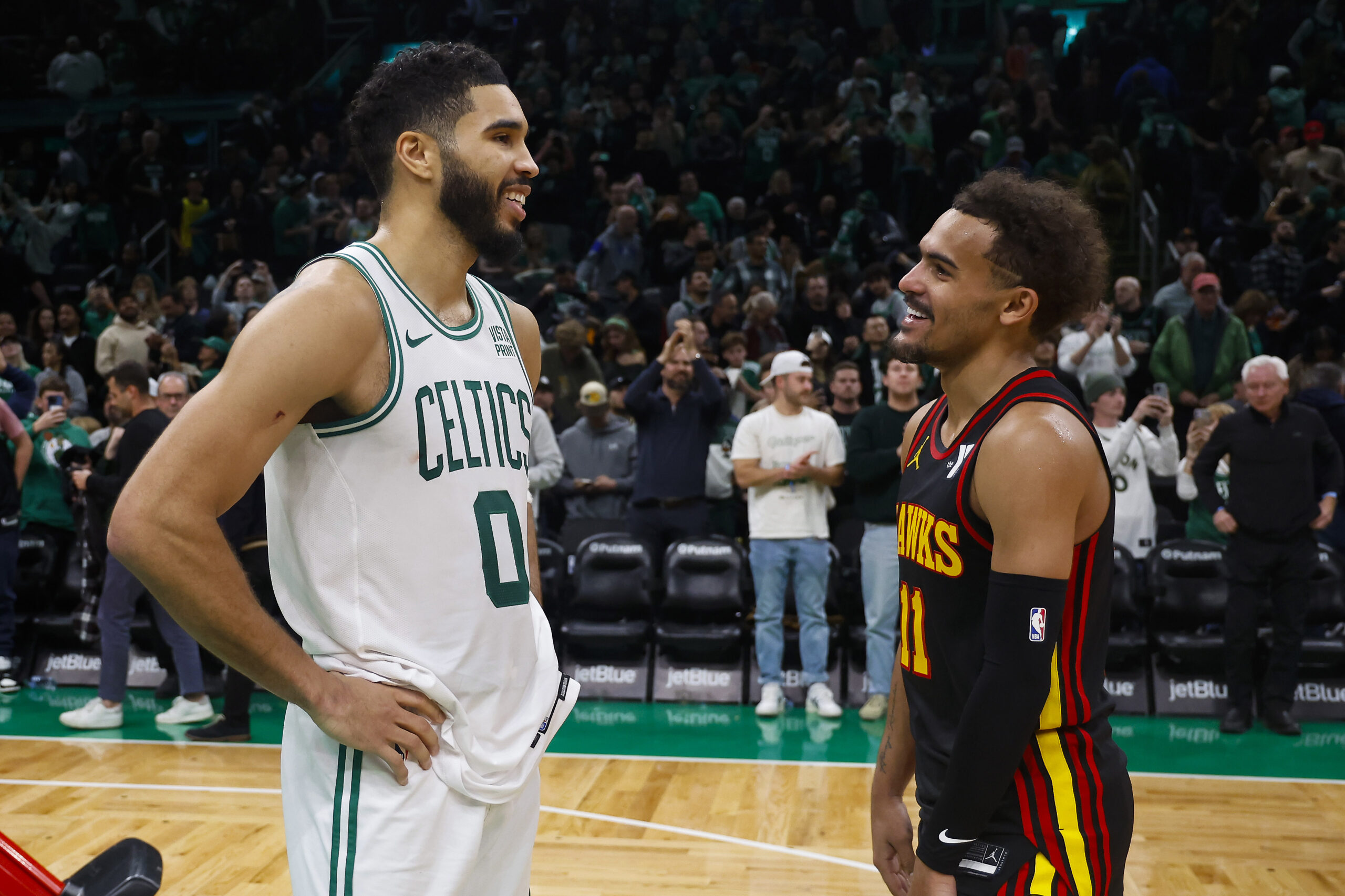 Nov 26, 2023; Boston, Massachusetts, USA; Boston Celtics forward Jayson Tatum (0) shares a laugh with Atlanta Hawks guard Trae Young (11) after their game at TD Garden.