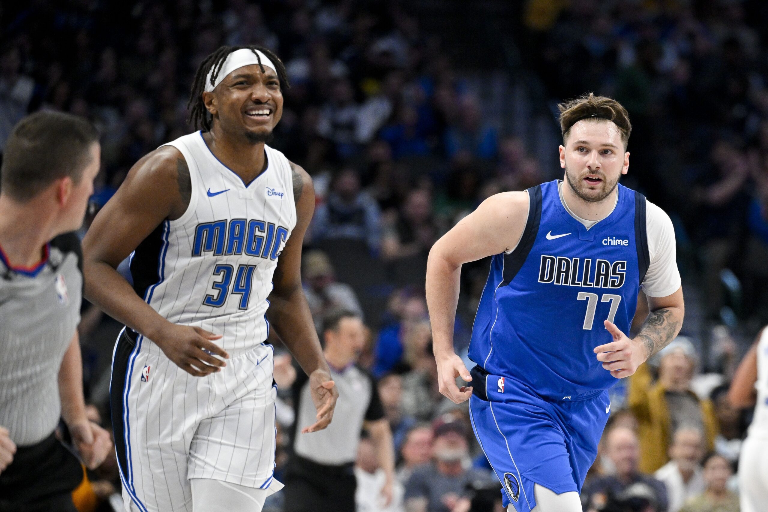 Jan 29, 2024; Dallas, Texas, USA; Orlando Magic center Wendell Carter Jr. (34) and Dallas Mavericks guard Luka Doncic (77) run back up the court during the first quarter at the American Airlines Center.