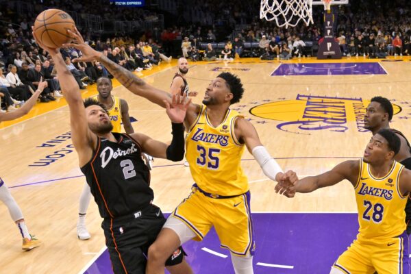 Feb 13, 2024; Los Angeles, California, USA; Los Angeles Lakers forward Christian Wood (35) blocks a shot by Detroit Pistons guard Cade Cunningham (2) in the second half at Crypto.com Arena. Mandatory Credit: Jayne Kamin-Oncea-USA TODAY Sports