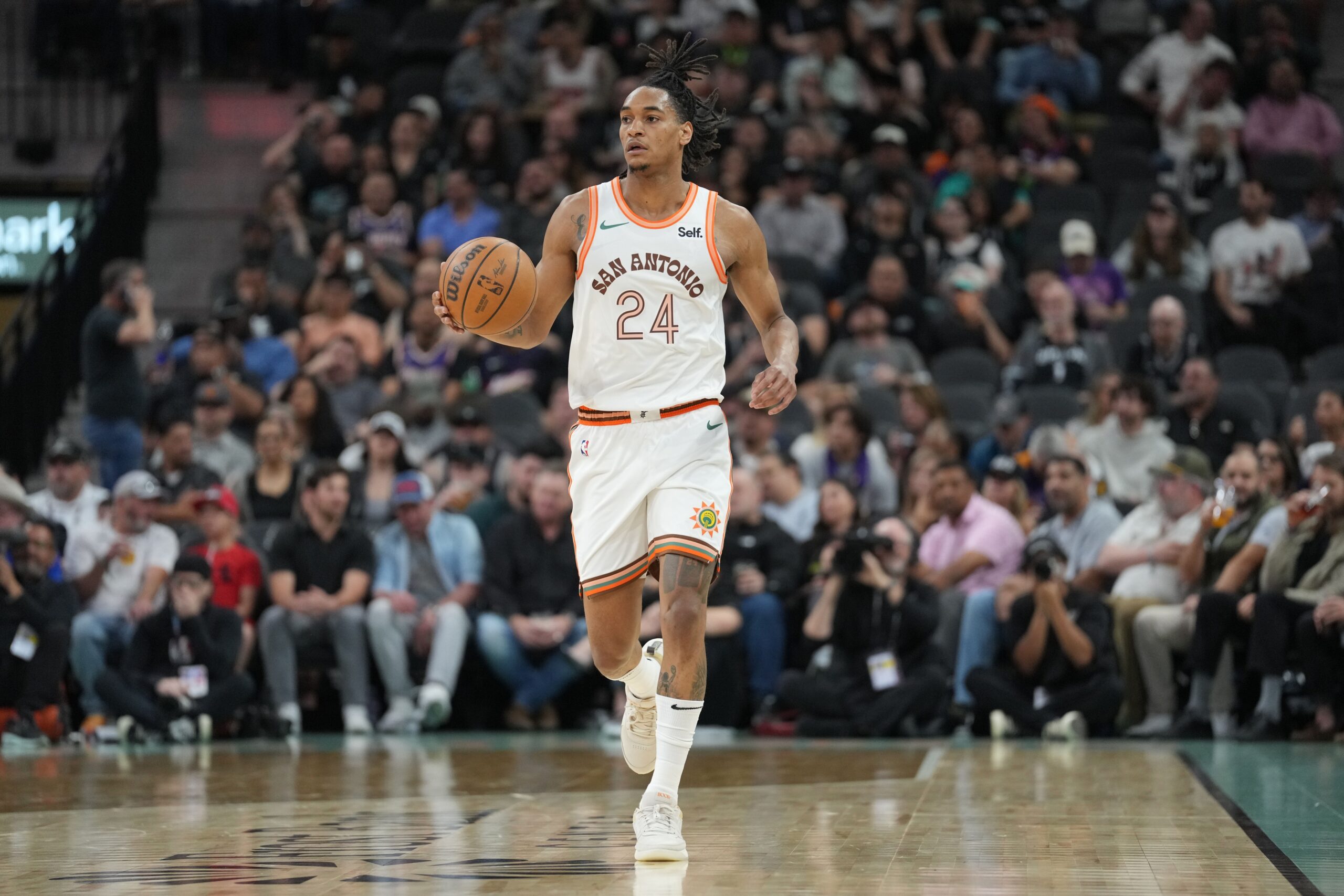 Mar 25, 2024; San Antonio, Texas, USA; San Antonio Spurs guard Devin Vassell (24) dribbles in the first half against the Phoenix Suns at Frost Bank Center.