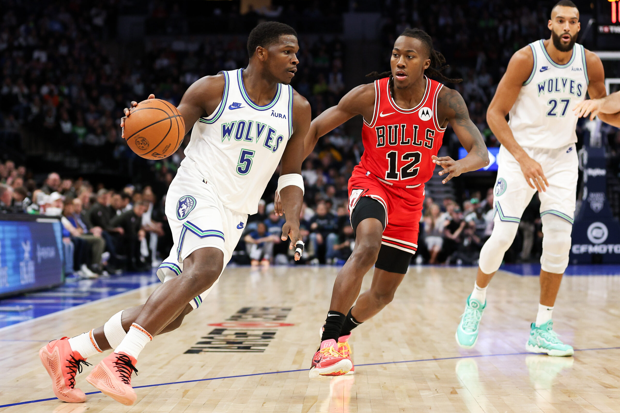 Mar 31, 2024; Minneapolis, Minnesota, USA; Minnesota Timberwolves guard Anthony Edwards (5) works around Chicago Bulls guard Ayo Dosunmu (12) during the first half at Target Center.