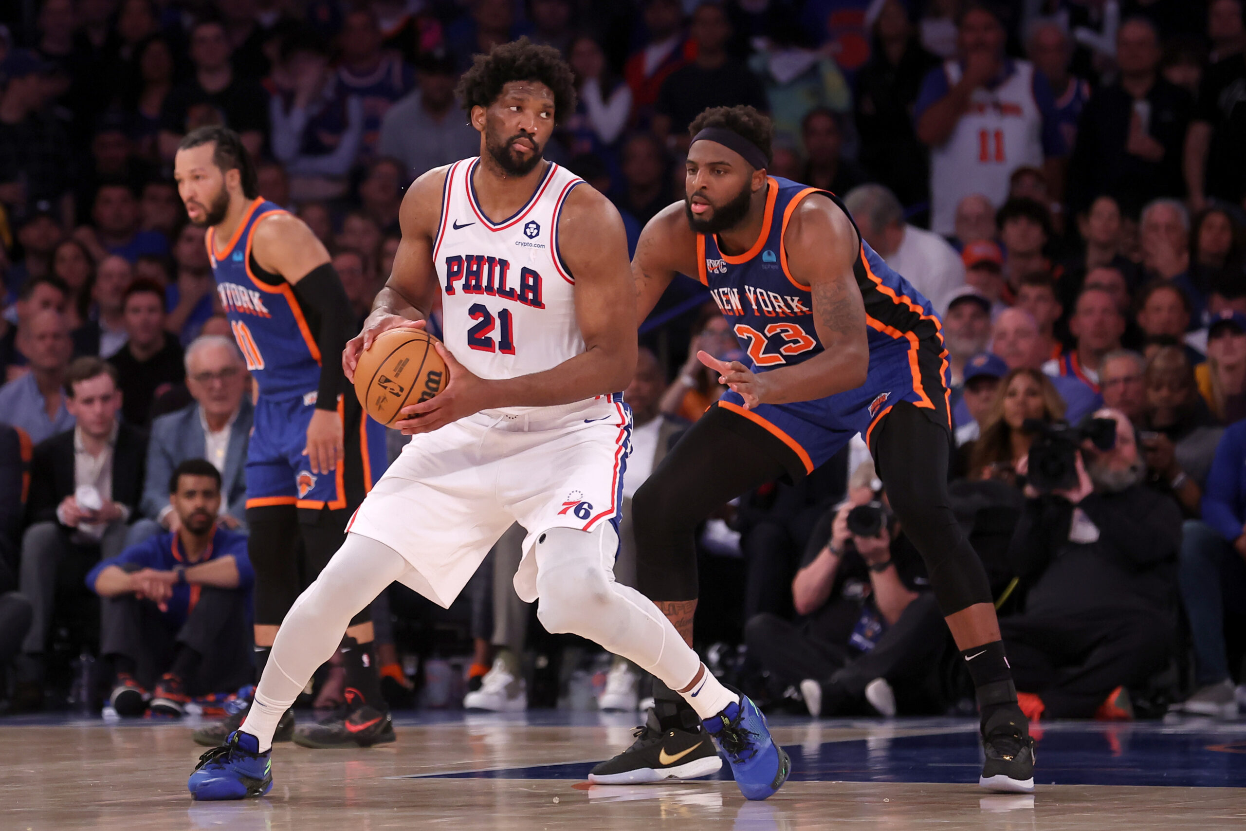 Apr 30, 2024; New York, New York, USA; Philadelphia 76ers center Joel Embiid (21) handles the ball against New York Knicks center Mitchell Robinson (23) during overtime in game 5 of the first round of the 2024 NBA playoffs at Madison Square Garden.