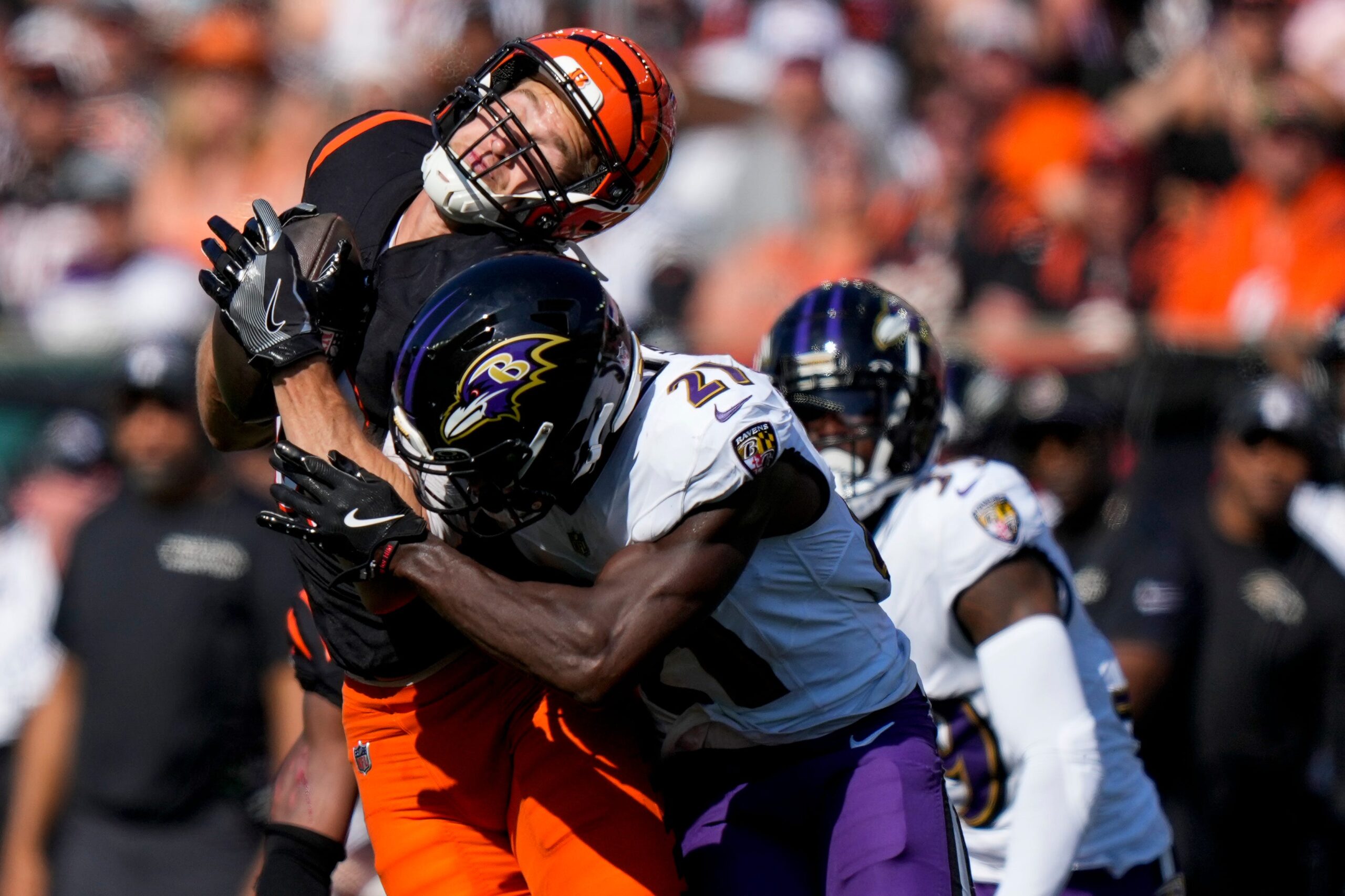 NFL; Cincinnati Bengals tight end Mike Gesicki (88) is hit hard by Baltimore Ravens defensive back Brandon Stephens (21) as he catches a pass for a first down in the third quarter of the NFL Week 5 game between the Cincinnati Bengals and Baltimore Ravens at Paycor Stadium in downtown Cincinnati on Sunday, Oct. 6, 2024. The Bengals fell to 1-4 on the season with a 41-38 loss to the Ravens.