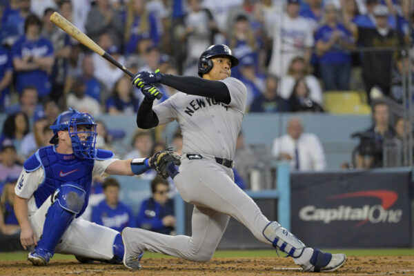 Oct 26, 2024; Los Angeles, California, USA; New York Yankees outfielder Juan Soto (22) hits a solo home run in the third inning against the Los Angeles Dodgers during game two of the 2024 MLB World Series at Dodger Stadium. Mandatory Credit: Jayne Kamin-Oncea-Imagn Images