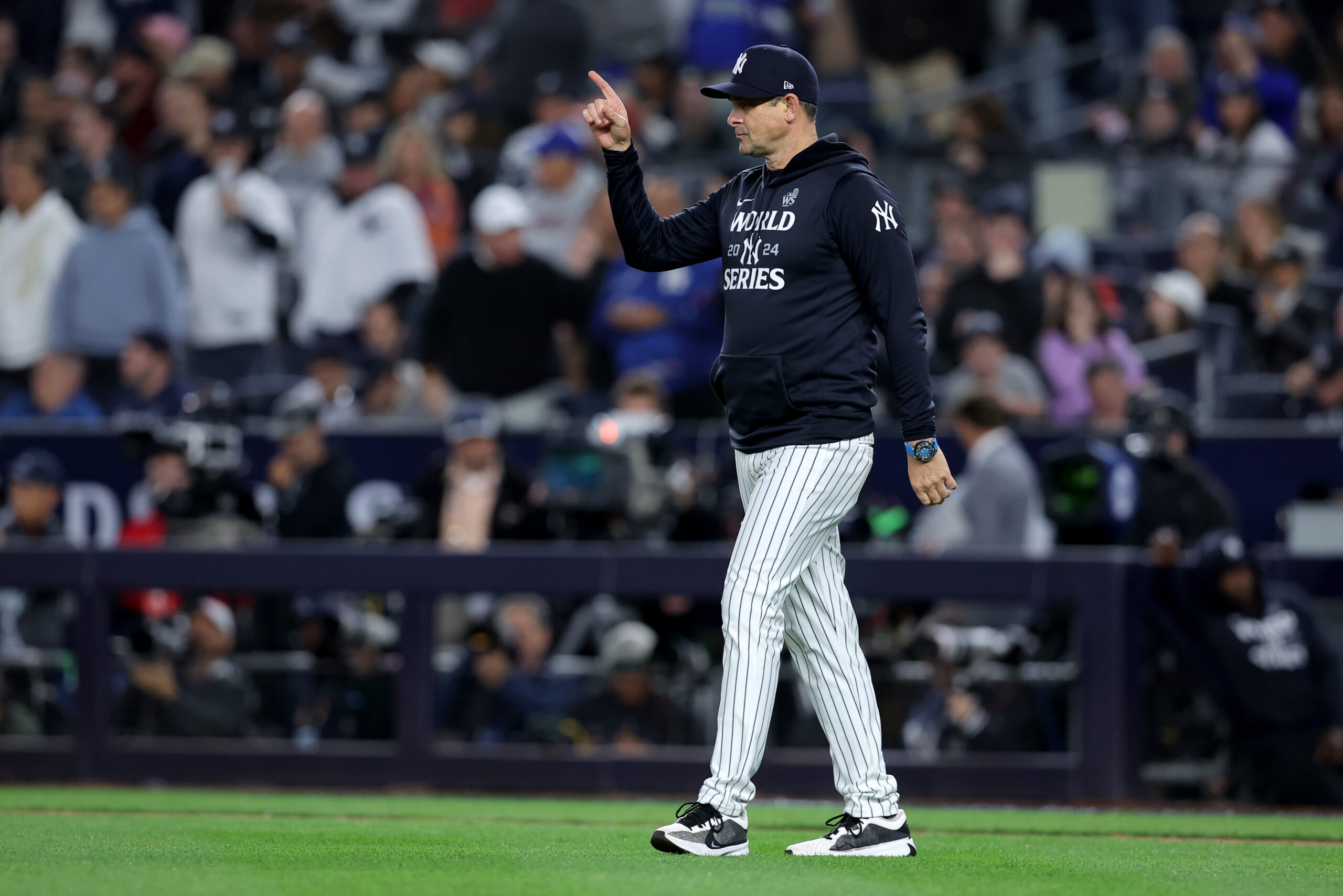 Oct 29, 2024; New York, New York, USA; New York Yankees manager Aaron Boone (17) makes a pitching change during the fifth inning against the Los Angeles Dodgers in game four of the 2024 MLB World Series at Yankee Stadium. Mandatory Credit: Brad Penner-Imagn Images