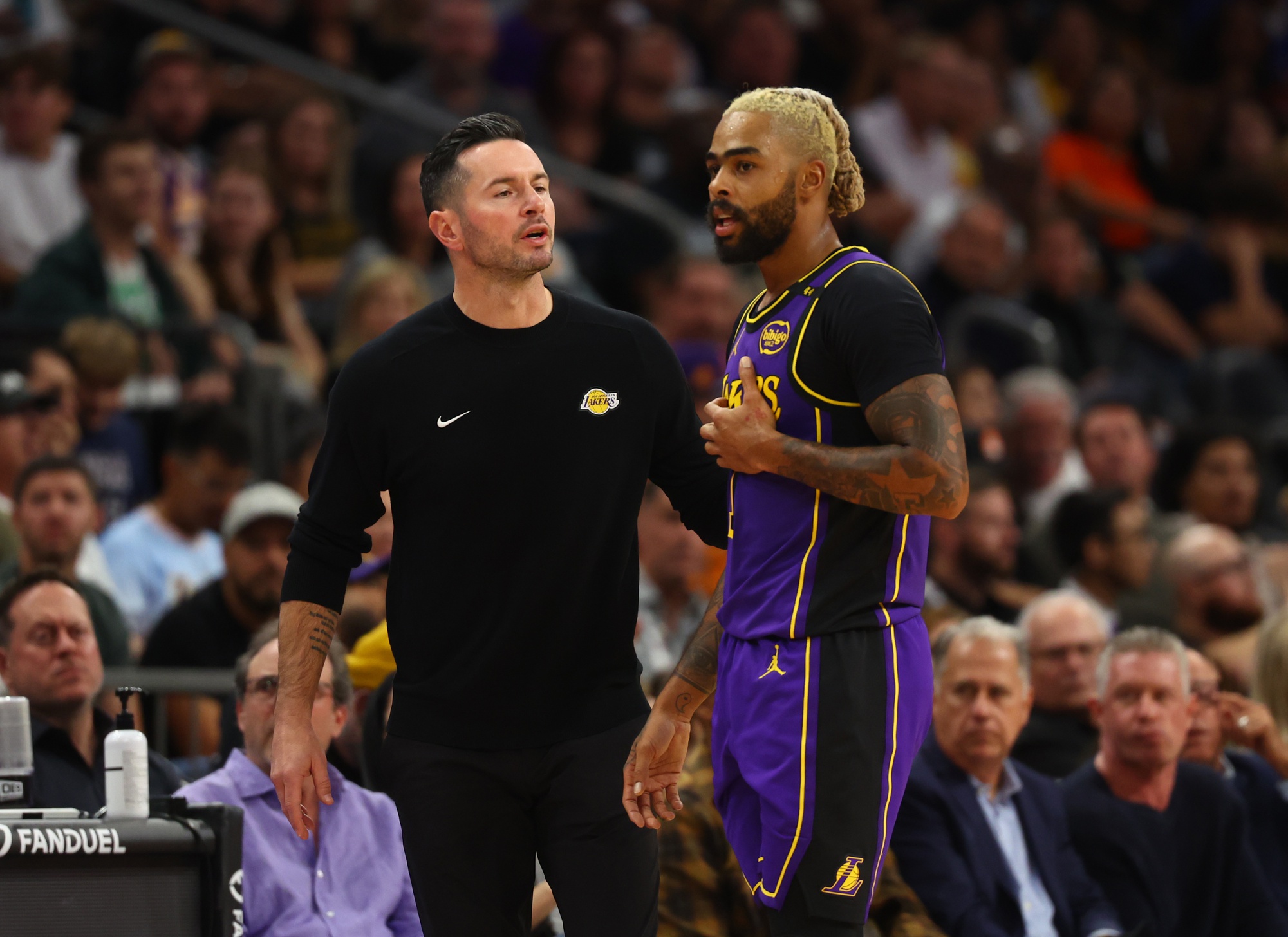 Oct 28, 2024; Phoenix, Arizona, USA; Los Angeles Lakers head coach JJ Redick with guard D'Angelo Russell (1) against the Phoenix Suns at Footprint Center. Mandatory Credit: Mark J. Rebilas-Imagn Images