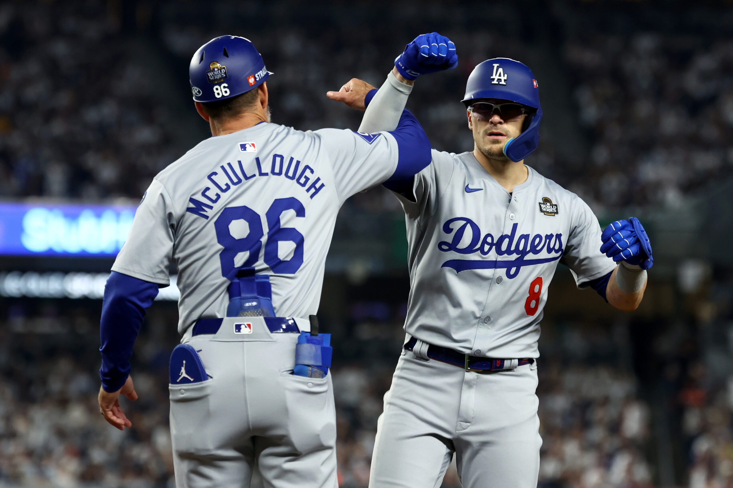 Oct 30, 2024; New York, New York, USA; Los Angeles Dodgers third baseman Enrique Hernandez (8) celebrates with first base coach Clayton McCullough (86) during the fifth inning against the New York Yankees in game five of the 2024 MLB World Series at Yankee Stadium. Mandatory Credit: Vincent Carchietta-Imagn Images