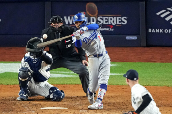 Oct 30, 2024; New York, New York, USA, Silver Slugger; Los Angeles Dodgers shortstop Mookie Betts (50) hits a sacrifice fly during the eighth inning against the New York Yankees in game four of the 2024 MLB World Series at Yankee Stadium. Mandatory Credit: Robert Deutsch-Imagn Images