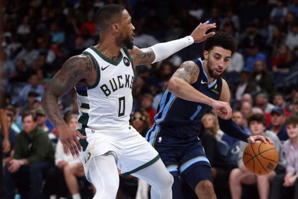 Oct 31, 2024; Memphis, Tennessee, USA; Memphis Grizzlies guard Scotty Pippen Jr. (1) drives to the basket as Milwaukee Bucks guard Damian Lillard (0) defends during the second half at FedExForum. Mandatory Credit: Petre Thomas-Imagn Images