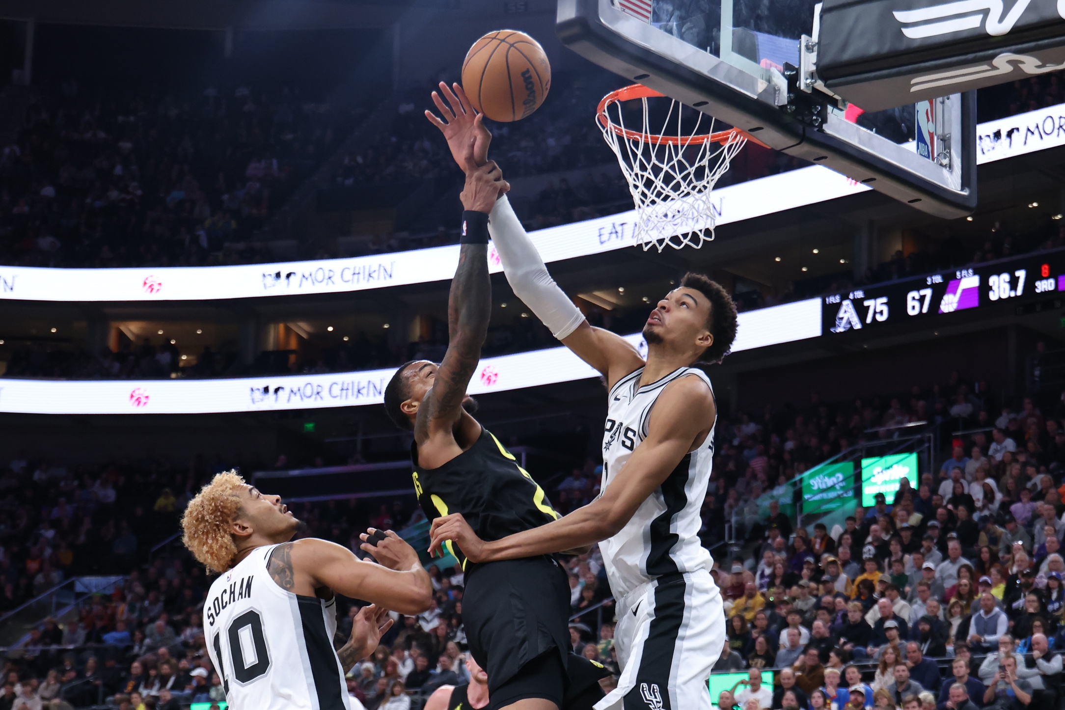 Oct 31, 2024; Salt Lake City, Utah, USA; Utah Jazz forward John Collins (20) goes to the basket against San Antonio Spurs center Victor Wembanyama (1) during the third quarter at Delta Center.