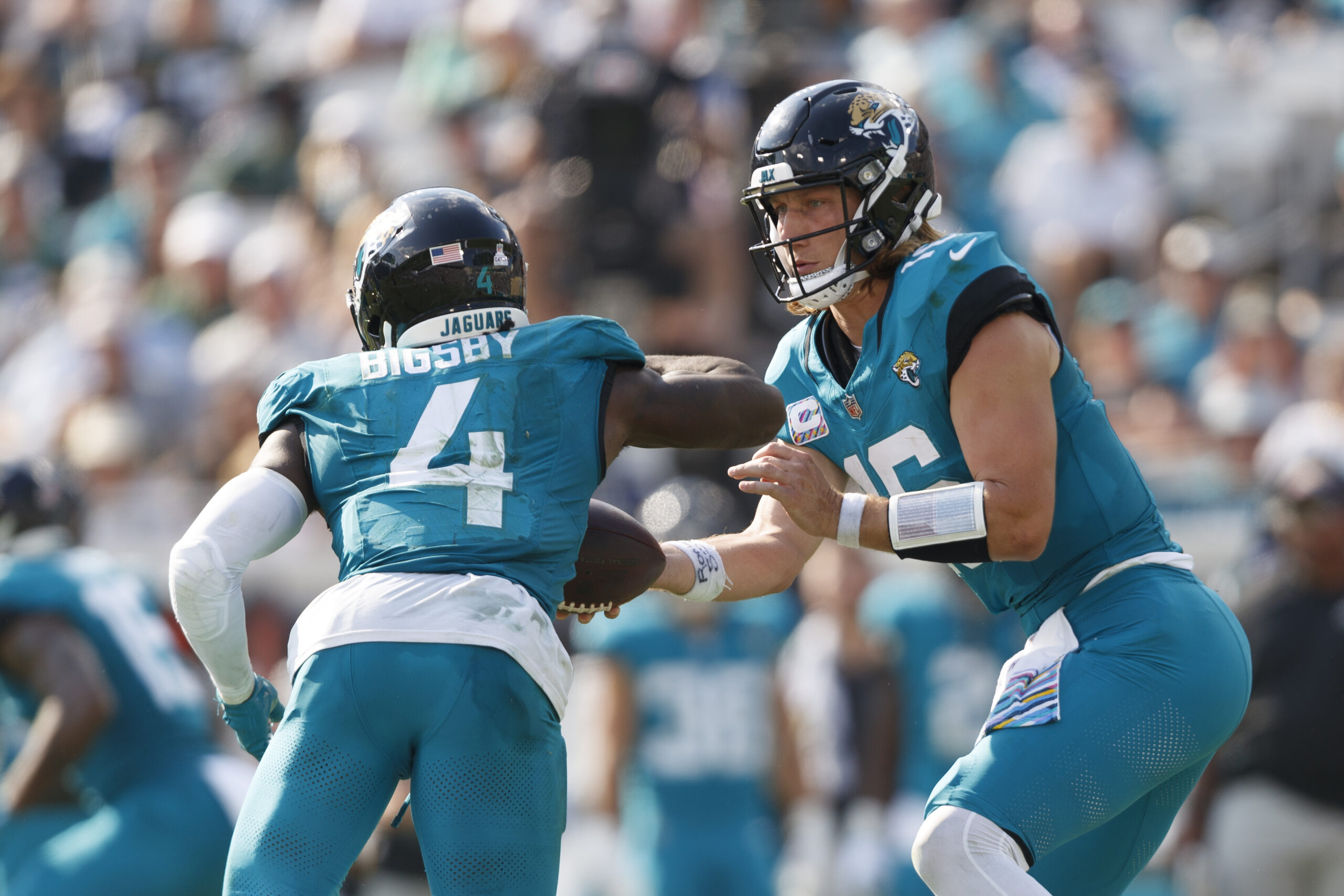 Oct 27, 2024; Jacksonville, Florida, USA;, Draft; Jacksonville Jaguars quarterback Trevor Lawrence (16) hands the ball off to running back Tank Bigsby (4) against the Green Bay Packers during the third quarter at EverBank Stadium. Mandatory Credit: Morgan Tencza-Imagn Images