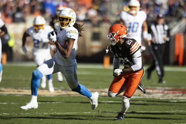 Nov 3, 2024; Cleveland, Ohio, USA; Los Angeles Chargers wide receiver Quentin Johnston (1) runs the ball as Cleveland Browns cornerback Denzel Ward (21) chases him during the second quarter at Huntington Bank Field. Mandatory Credit: Scott Galvin-Imagn Images