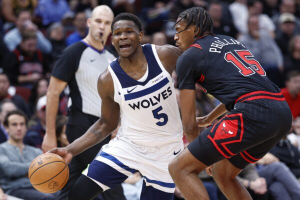 Nov 7, 2024; Chicago, Illinois, USA; Minnesota Timberwolves guard Anthony Edwards (5) drives to the basket against Chicago Bulls forward Julian Phillips (15) during the first half at United Center. Mandatory Credit: Kamil Krzaczynski-Imagn Images