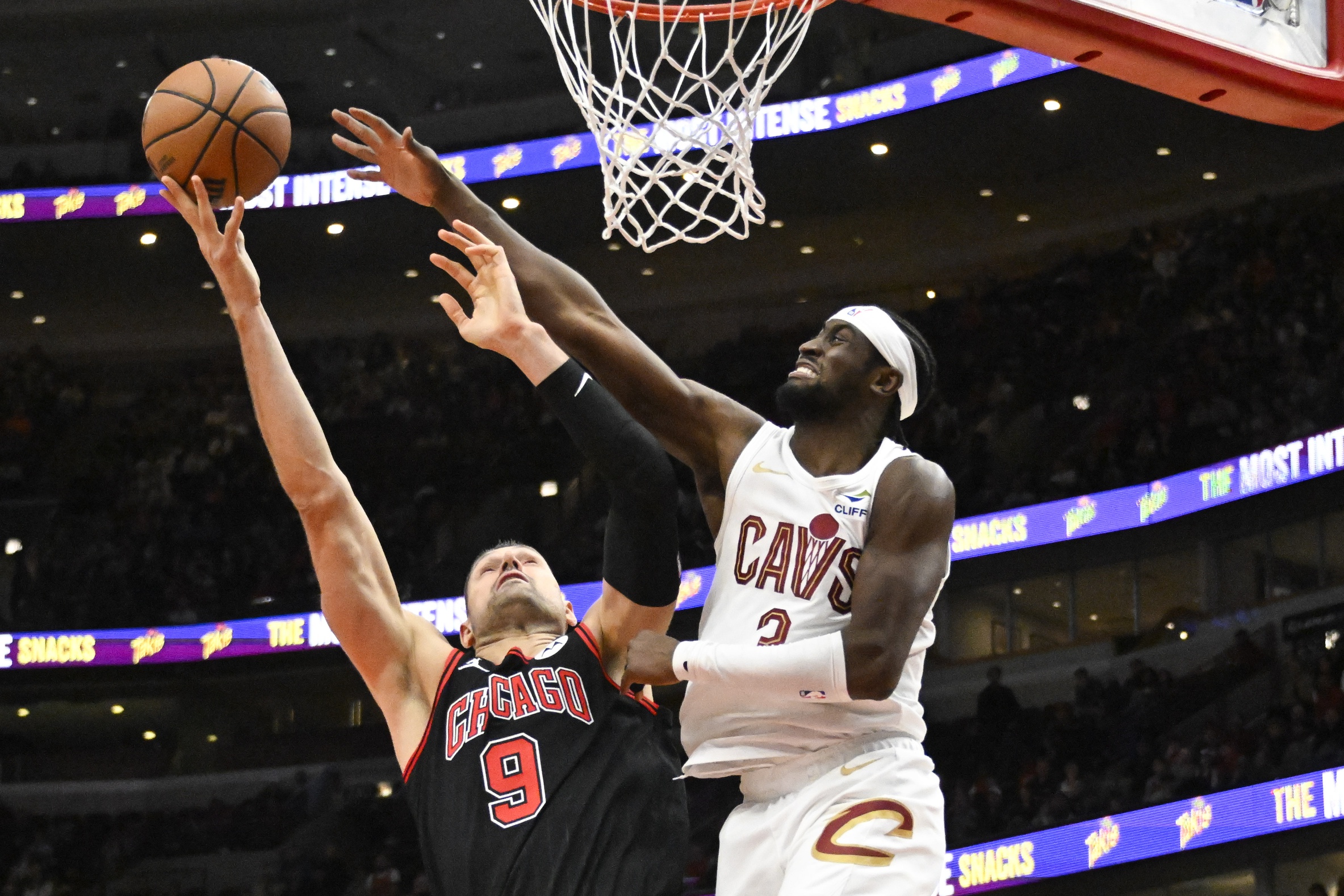 Nov 11, 2024; Chicago, Illinois, USA; Chicago Bulls center Nikola Vucevic (9) shoots against Cleveland Cavaliers guard Caris LeVert (3) during the second half at United Center. Mandatory Credit: Matt Marton-Imagn Images