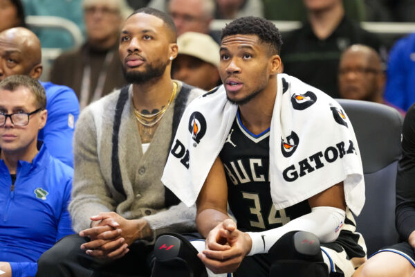 Nov 12, 2024; Milwaukee, Wisconsin, USA; Milwaukee Bucks forward Giannis Antetokounmpo (34) sits with guard Damian Lillard on the bench during the fourth quarter against the Toronto Raptors at Fiserv Forum.