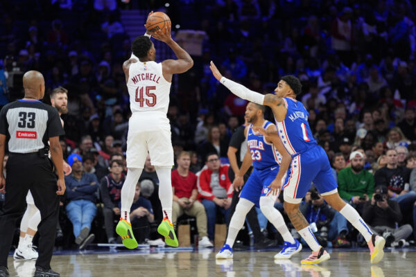 Nov 13, 2024; Philadelphia, Pennsylvania, USA; Cleveland Cavaliers guard Donovan Mitchell (45) shoots the ball against Philadelphia 76ers forward KJ Martin (1) in the second quarter at Wells Fargo Center.