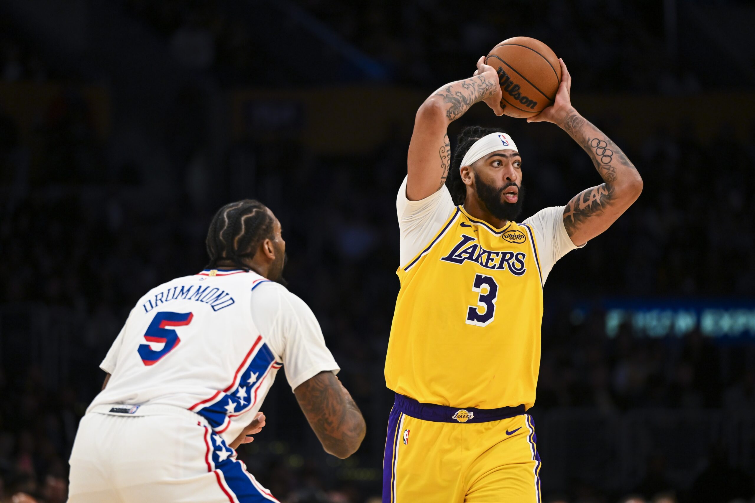 Nov 8, 2024; Los Angeles, California, USA; Los Angeles Lakers forward Anthony Davis (3) looks to pass against Philadelphia 76ers center Andre Drummond (5) during the second half at Crypto.com Arena.